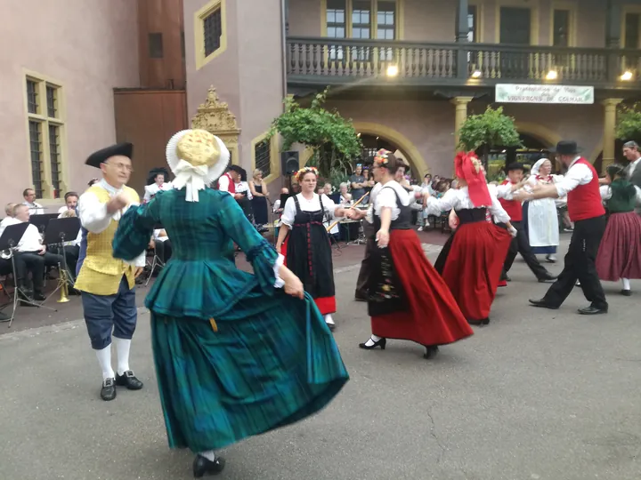 Folklore dancing in the evening at Colmar, Alsace (France)